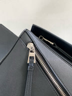 Loewe dark blue leather bag showing zipper pull and inner edge