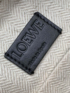 Loewe leather brand tag patch with embossed LOEWE text on bag lining