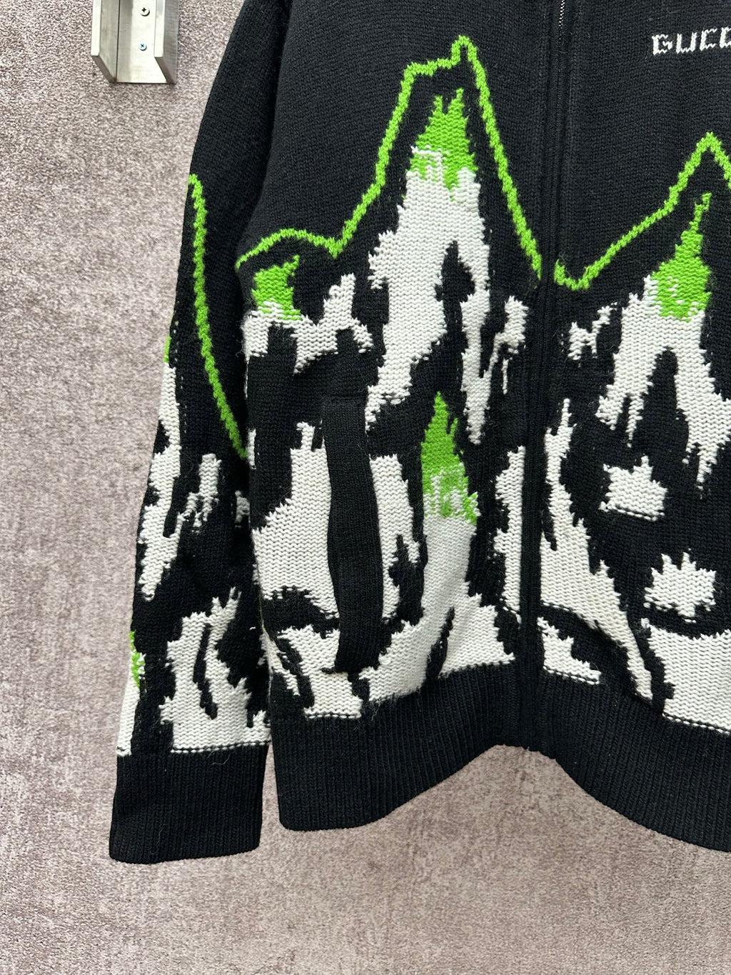 Gucci black knit sweater front view with white-and-green mountain graphic panel