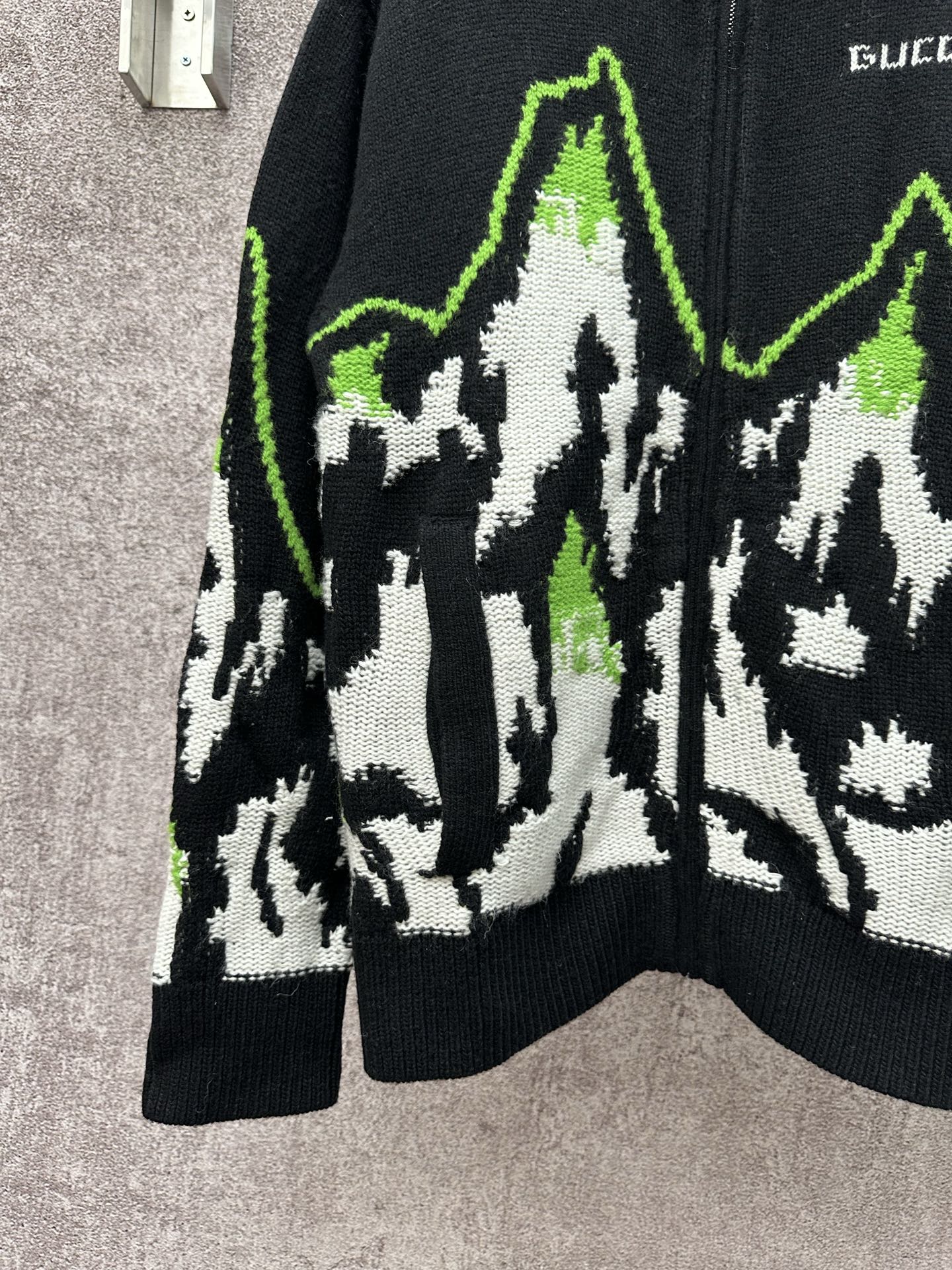 Gucci black knit sweater front view with white-and-green mountain graphic panel