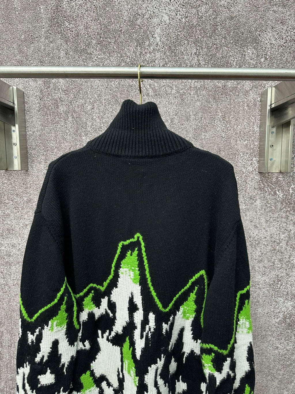 Gucci black knit sweater with neon green outlined mountain graphic and ribbed turtleneck