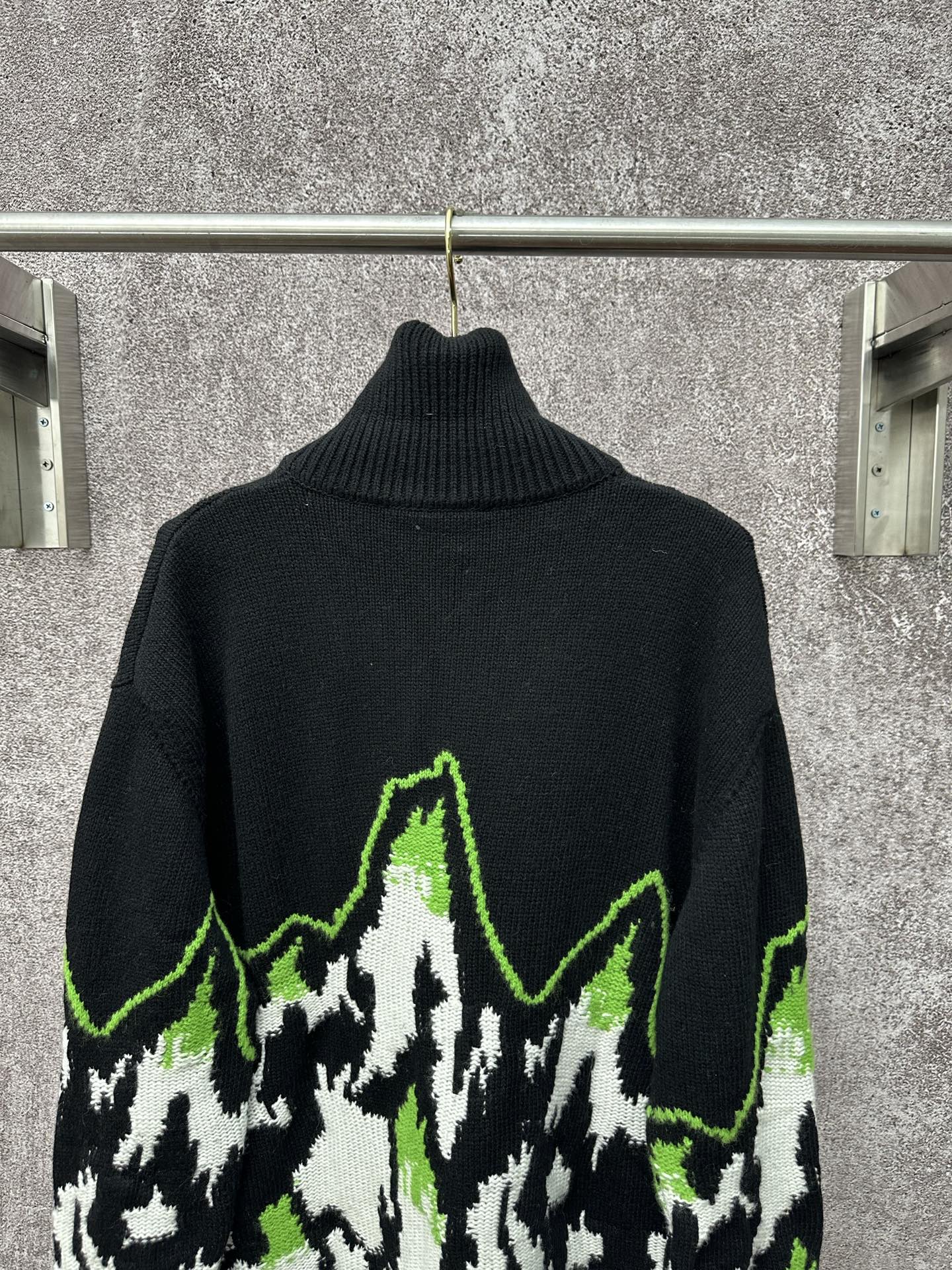 Gucci black knit sweater with neon green outlined mountain graphic and ribbed turtleneck