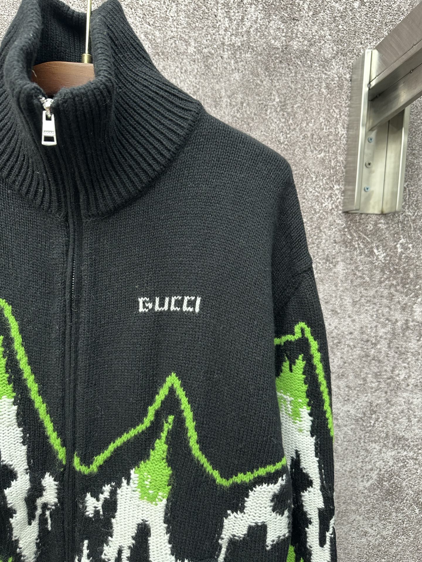 Gucci black knit zip sweater with ribbed collar and small Gucci logo on chest