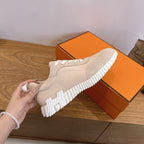Unisex beige sneakers with white laces and ridged chunky white sole