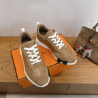 Tan suede sneakers with white laces and white-and-black ridged platform sole