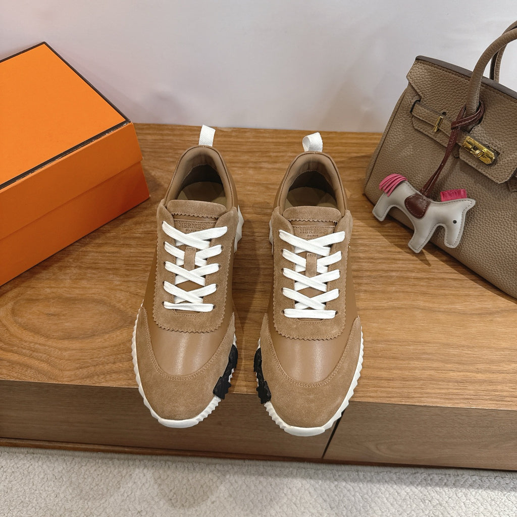 Tan suede sneakers with white laces and thick white-and-black ridged sole