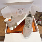 Beige lace-up sneakers with ribbed white sole and stitched side panels