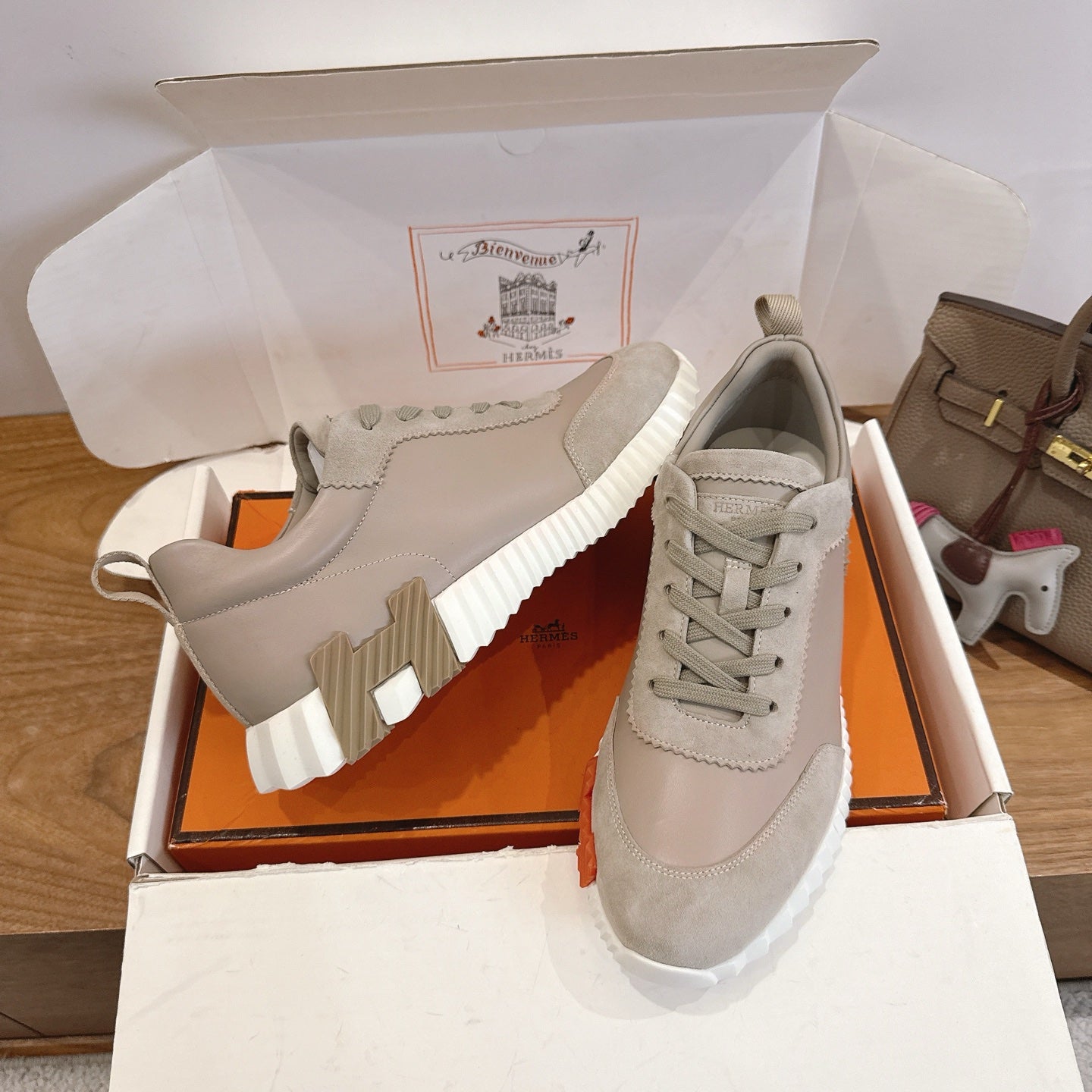 Beige lace-up sneakers with ribbed white sole and stitched side panels