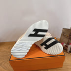 Unisex beige sneakers showing black-and-white outsole tread