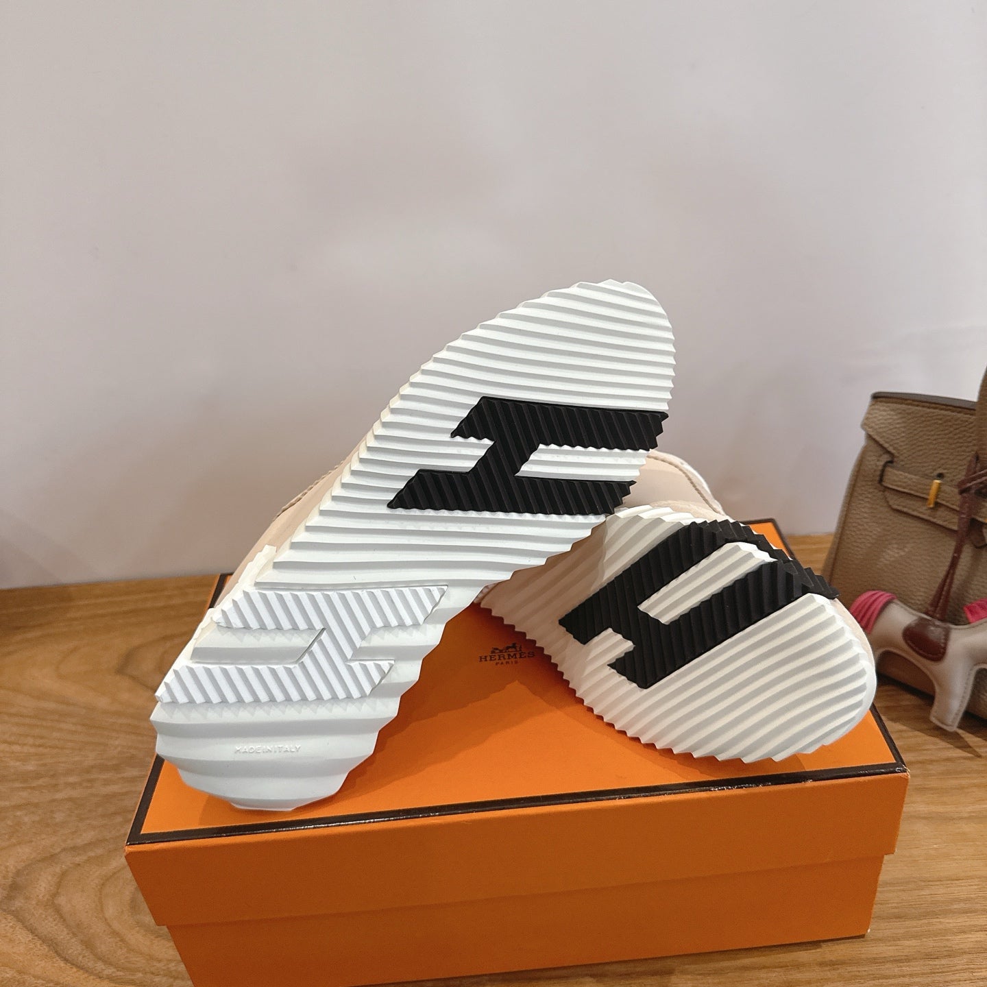Unisex beige sneakers showing black-and-white outsole tread