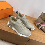 Hermes unisex sneakers pair, light gray suede with lace-up and ridged white rubber sole