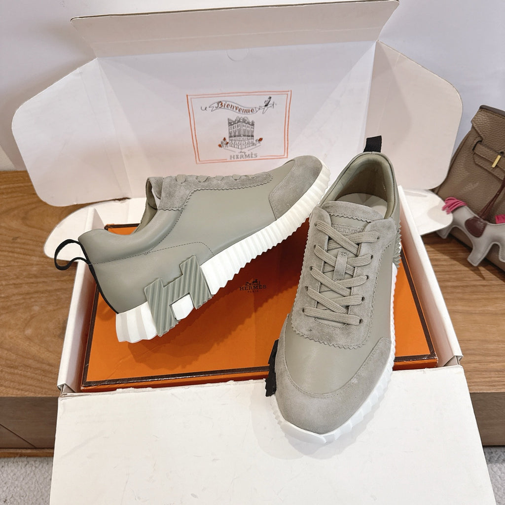 Hermes unisex sneakers with light gray suede uppers, lace-up design and thick white sole