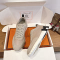 Unisex lace-up sneakers with white rubber sole, shown on orange box