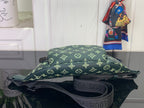 Green monogram belt bag with wide strap and black interior lining