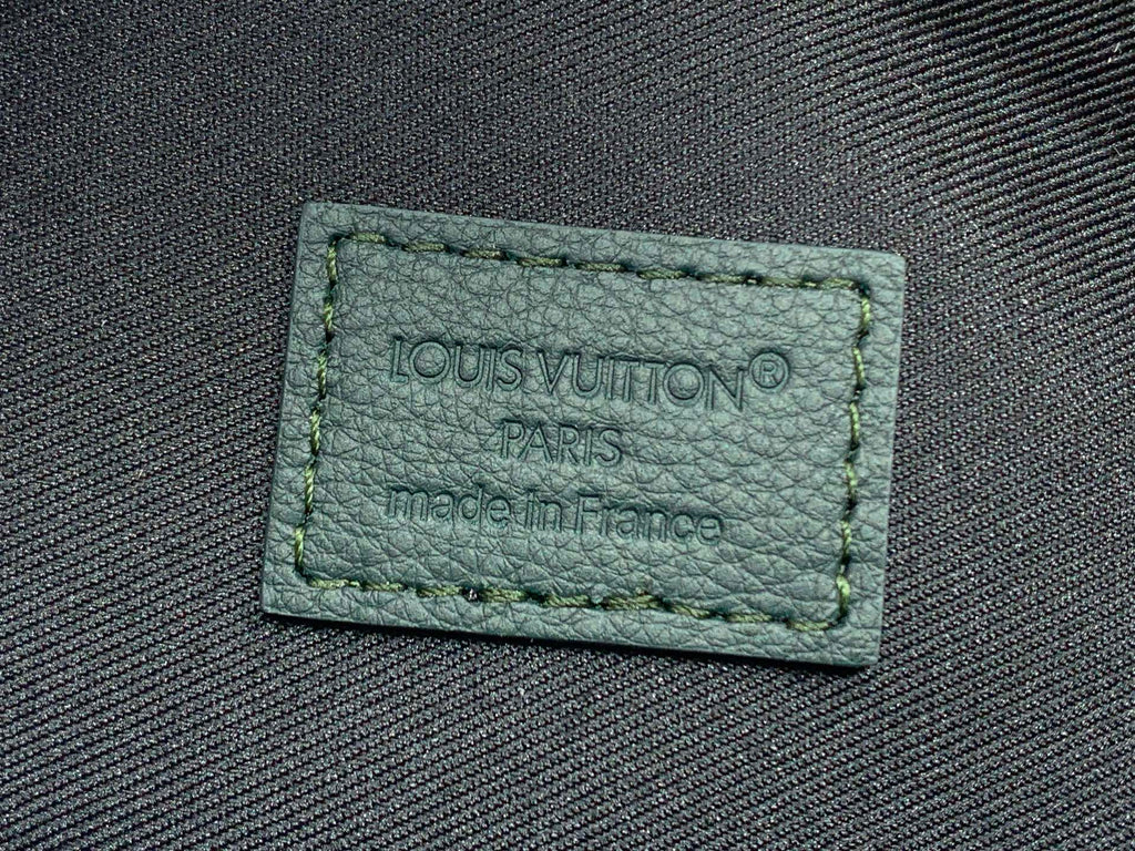 Green fabric label with stitched Louis Vuitton Paris text