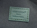 Green fabric label with stitched Louis Vuitton Paris text