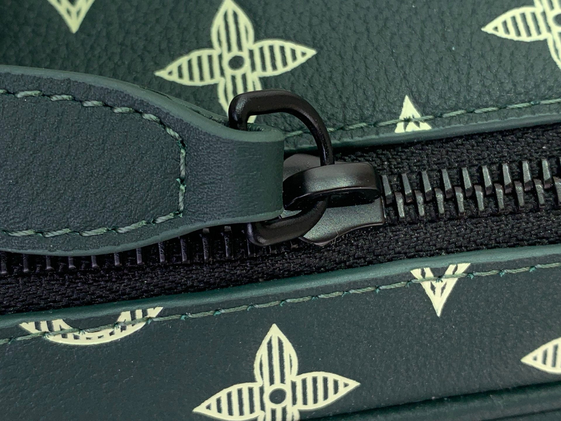 Louis Vuitton monogram bag zipper pull and teeth on dark green trim