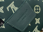 Dark green leather Louis Vuitton tag label with gold stitching detail