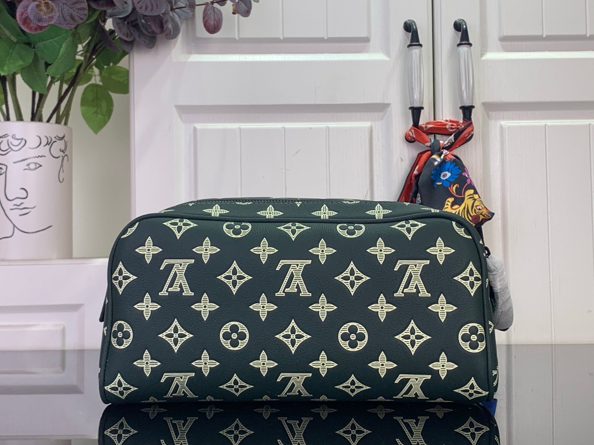 Louis Vuitton monogram toiletry bag with gold pattern, dark green, zip closure