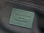 Louis Vuitton monogram label on dark green leather bag
