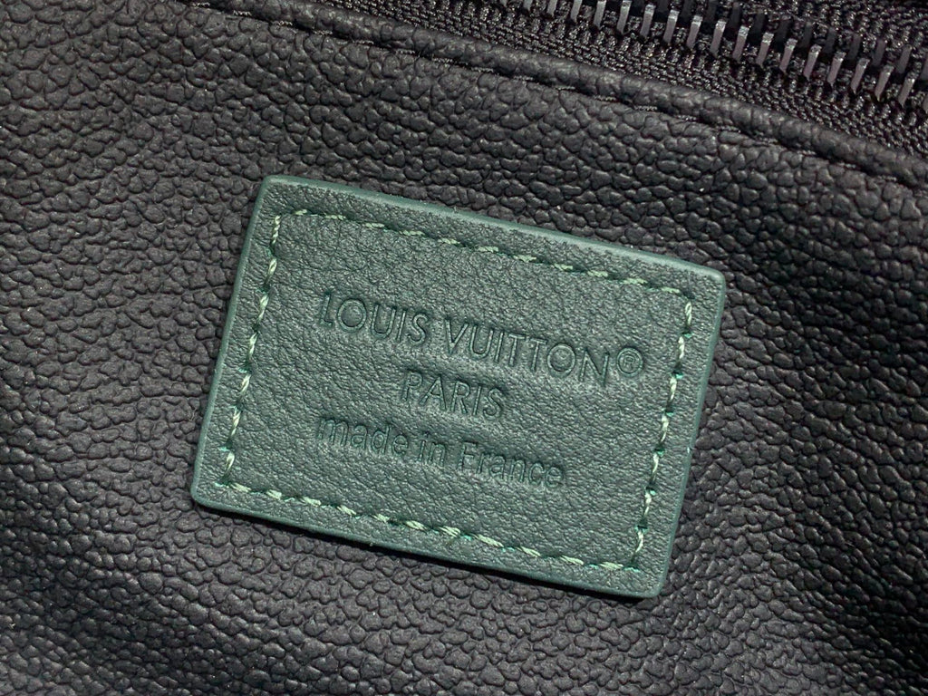 Louis Vuitton Paris label on dark green leather, stitched rectangle tag