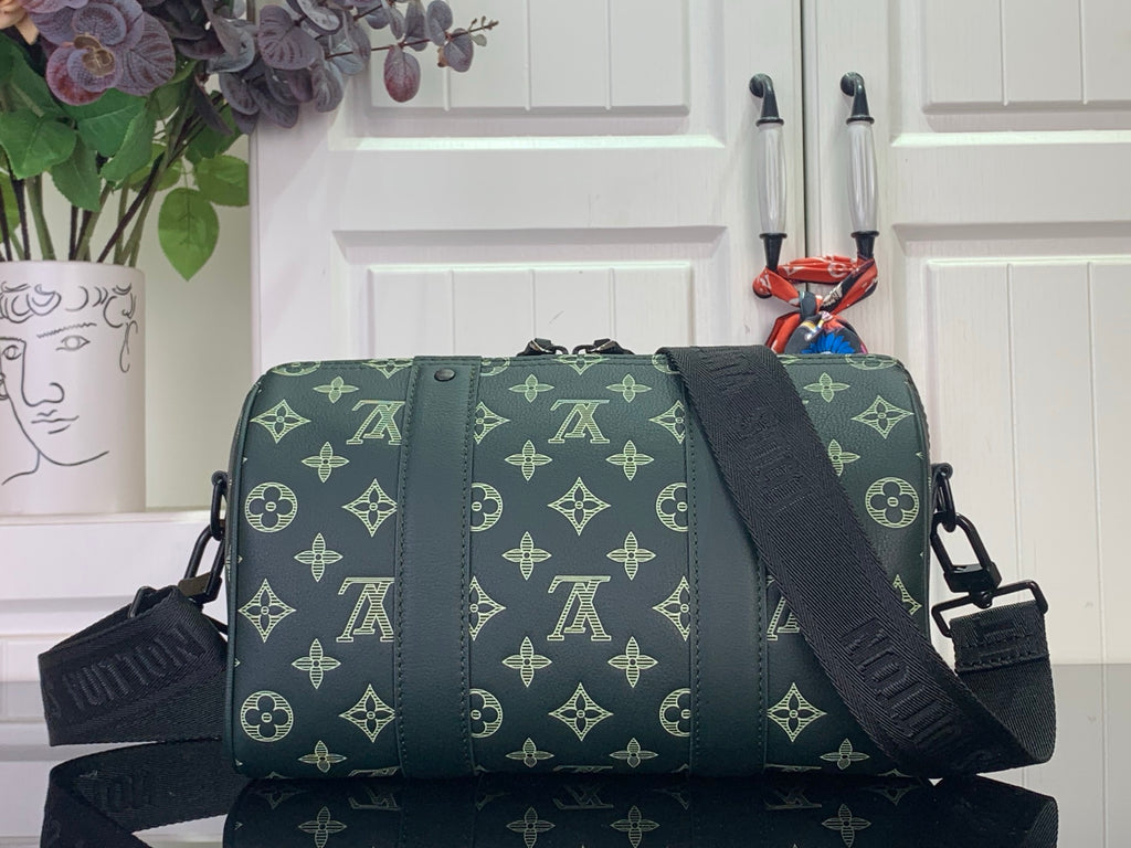 Green monogram duffel bag with crossbody strap and front zipper panel