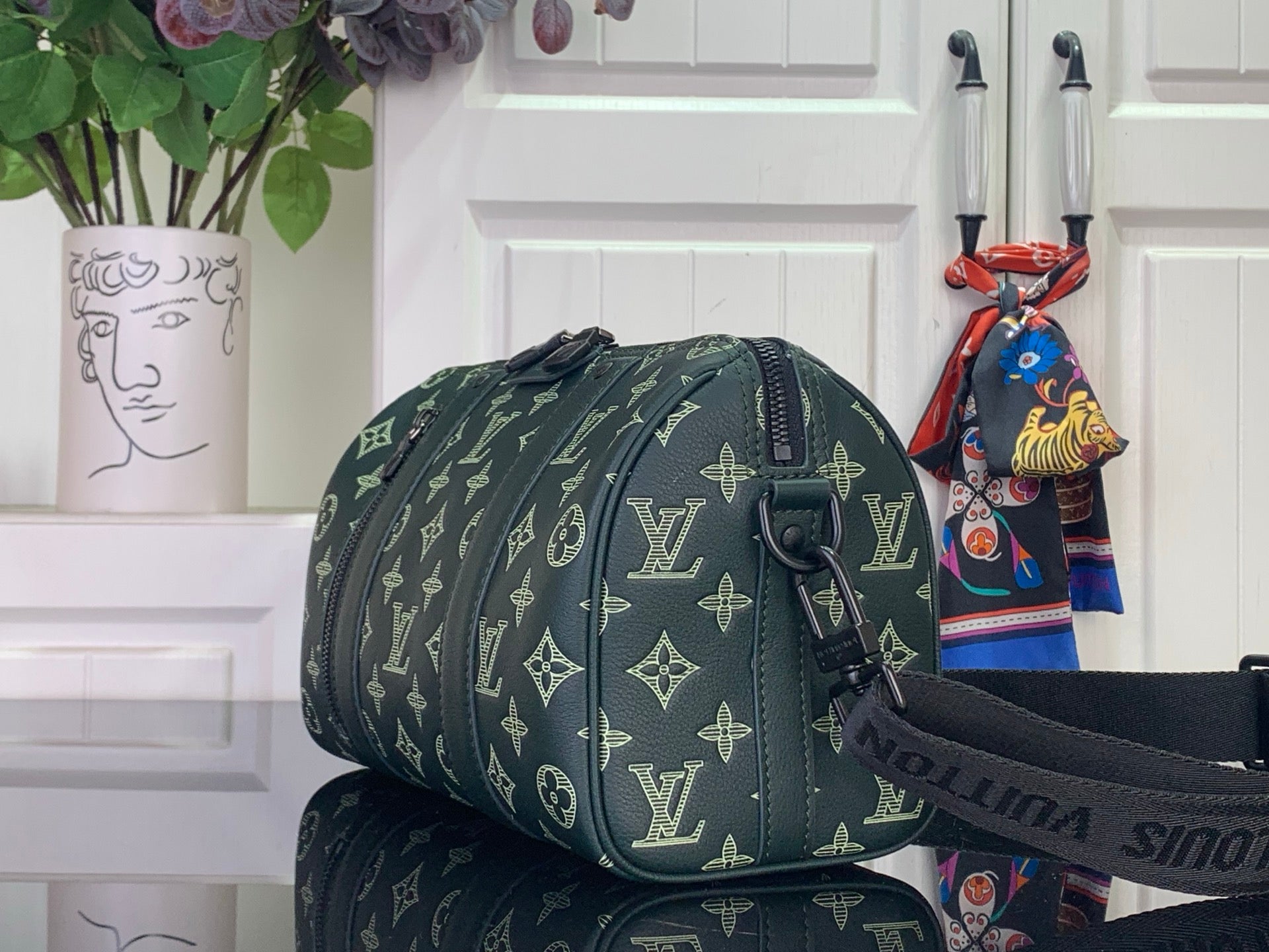 Louis Vuitton men's duffel bag with green monogram pattern and shoulder strap