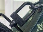 Green leather duffel bag with metal D-ring strap attachment and logo plate