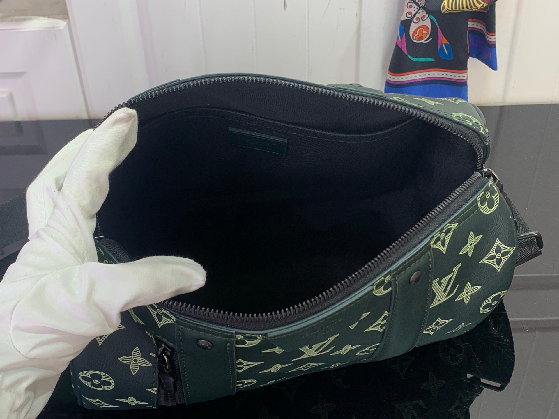 Louis Vuitton men's duffel bag interior with black lining and zipper opening