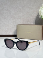 Bvlgari sunglasses with black rounded frames and dark lenses, gold-tone temple detail
