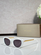 Bvlgari sunglasses with white rounded frames and dark lenses, gold-tone temples