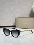 Bvlgari sunglasses with black round frames and dark lenses, gold-tone temple detail