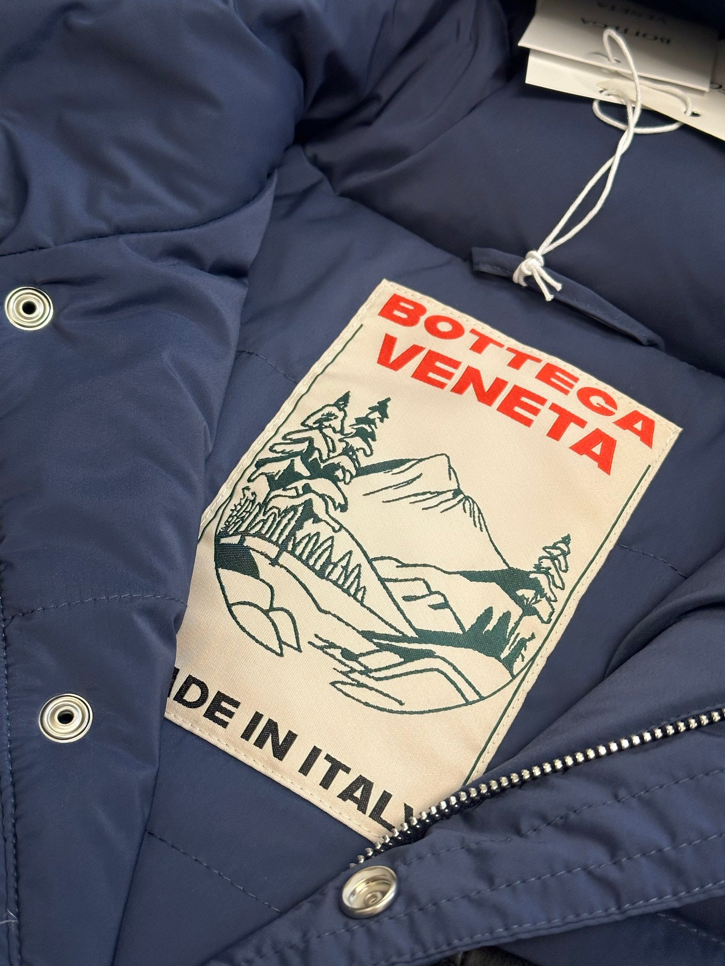 Off White puffer jacket with Bottega Veneta logo swing tag