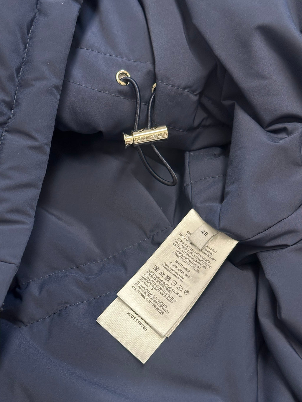 Off White puffer jacket with attached size and care swing tag