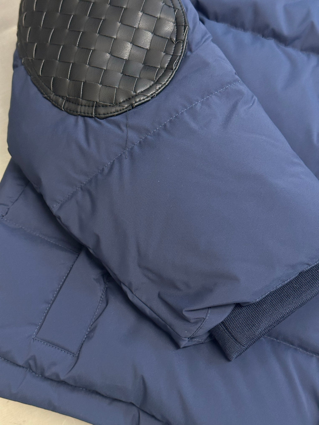 Off White dark blue puffer jacket with round woven-look patch on sleeve