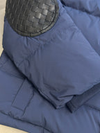 Off White dark blue puffer jacket with round woven-look patch on sleeve