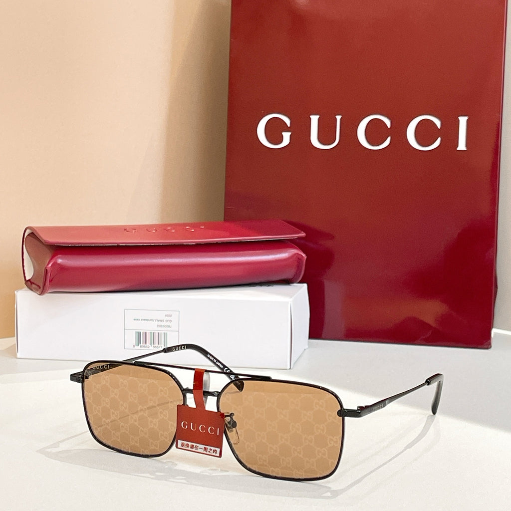 Gucci sunglasses with gold frame and tan tinted lenses, patterned temple detail