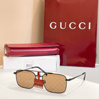 Gucci sunglasses with gold frame and tan tinted lenses, patterned temple detail
