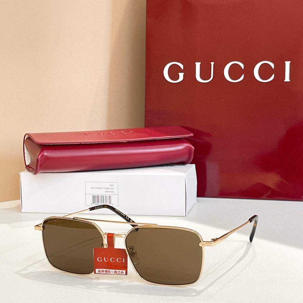 Gucci sunglasses with gold frame and olive-brown tinted lenses, metal bridge detail