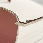Gucci sunglasses close-up of gold temple with circular logo emblem
