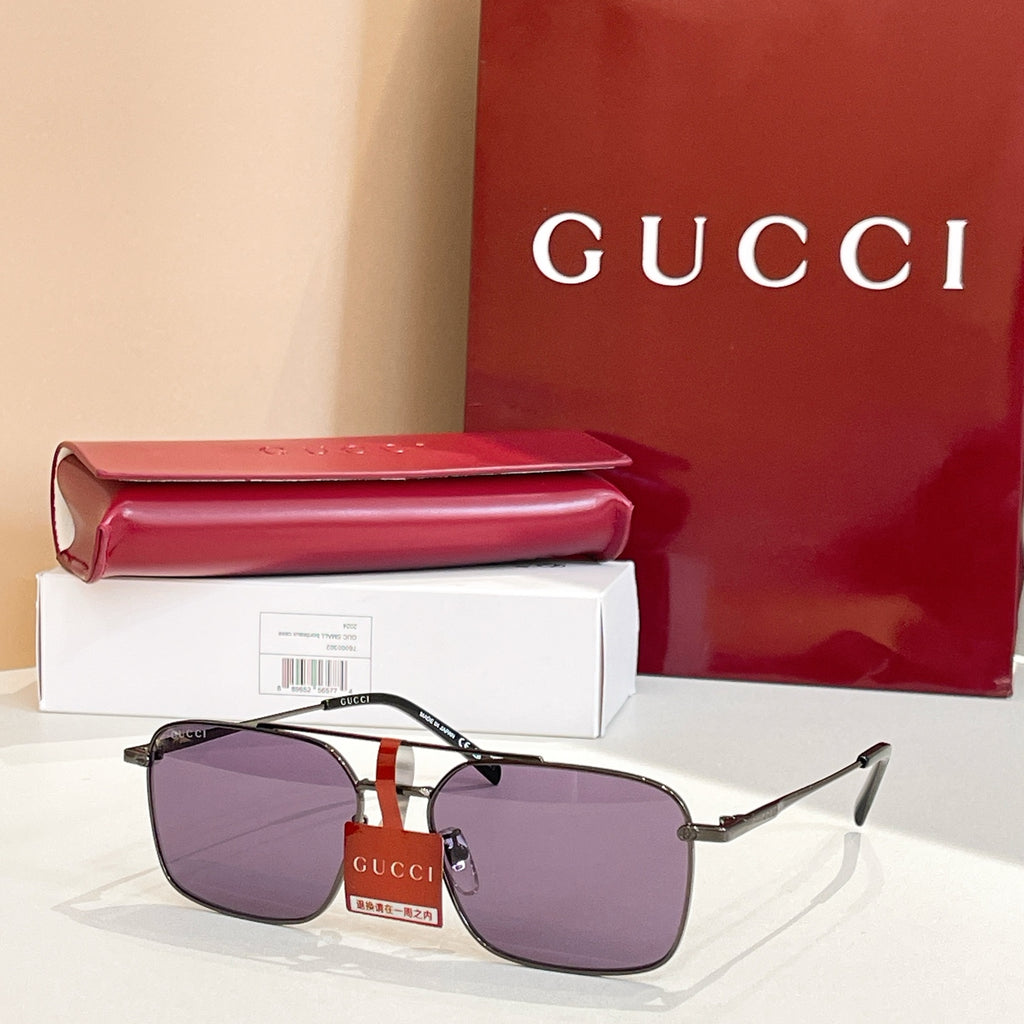 Gucci sunglasses with gold frame and purple tinted lenses, black temple arms