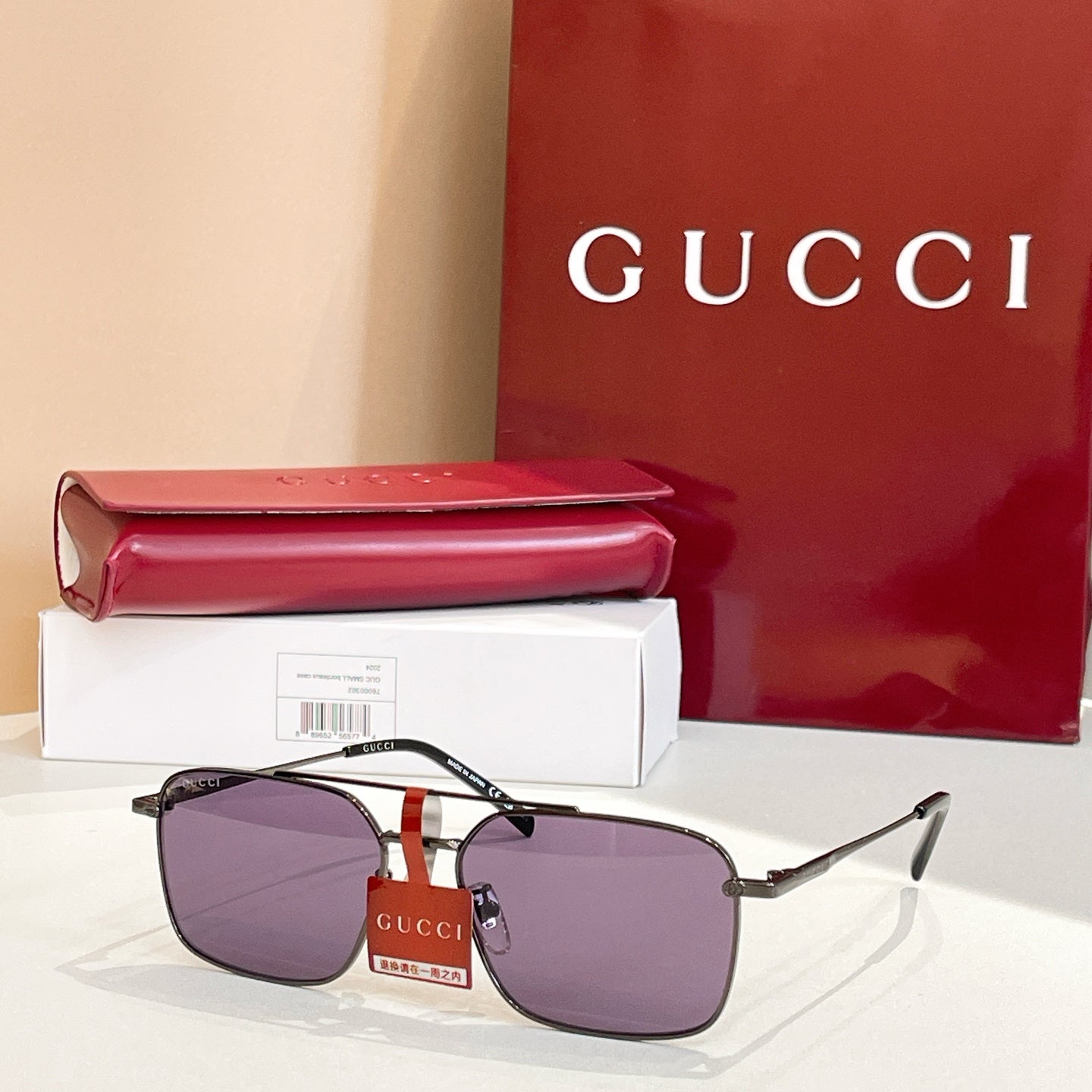 Gucci sunglasses with gold frame and purple tinted lenses, black temple arms