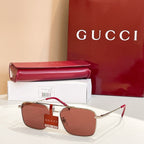 Gucci sunglasses with gold frame and brown red tinted lenses, slim metal arms