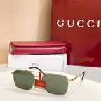 Gucci sunglasses with gold frame and dark green lenses, metal bridge detail