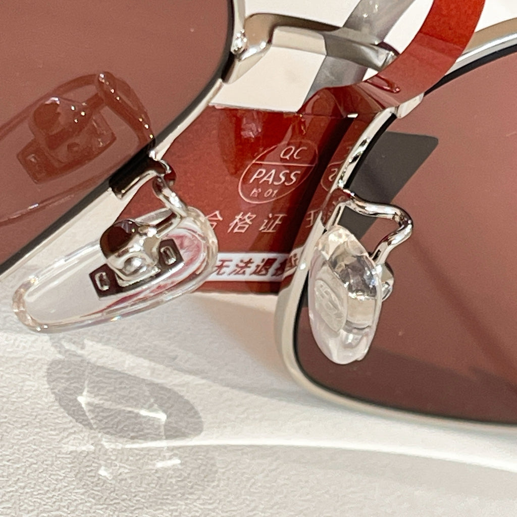 Gucci sunglasses close-up of clear lenses and metal frame with red temple strap