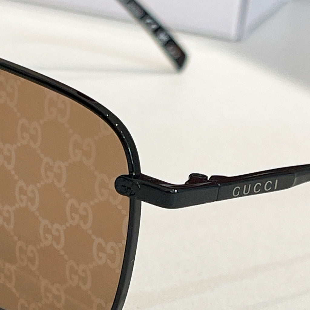 Black eyeglass temple with small brand lettering near hinge