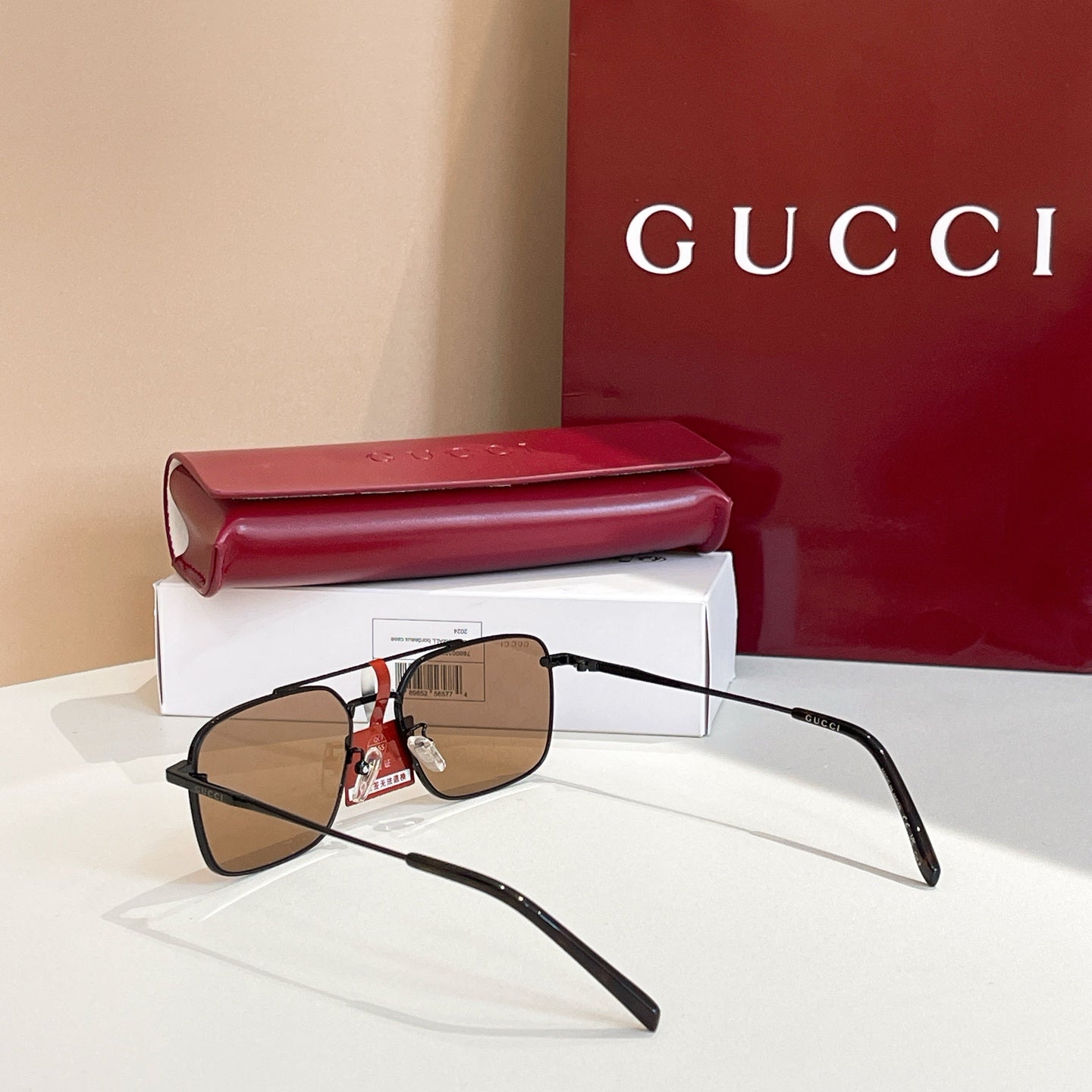 Black eyeglasses with brown lenses and red-striped detail at bridge