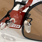 Close-up of black eyeglass frame with metal hinge hardware