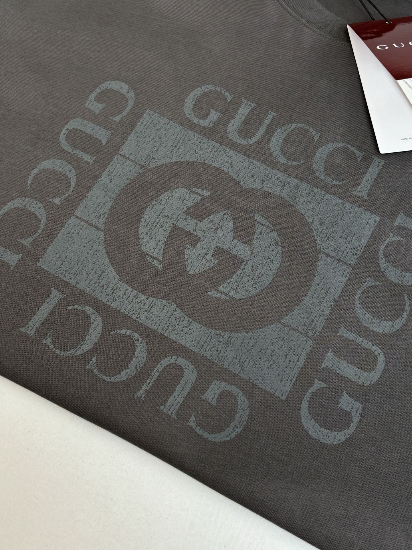 Gucci short-sleeve T-shirt close-up of dark gray GG logo print