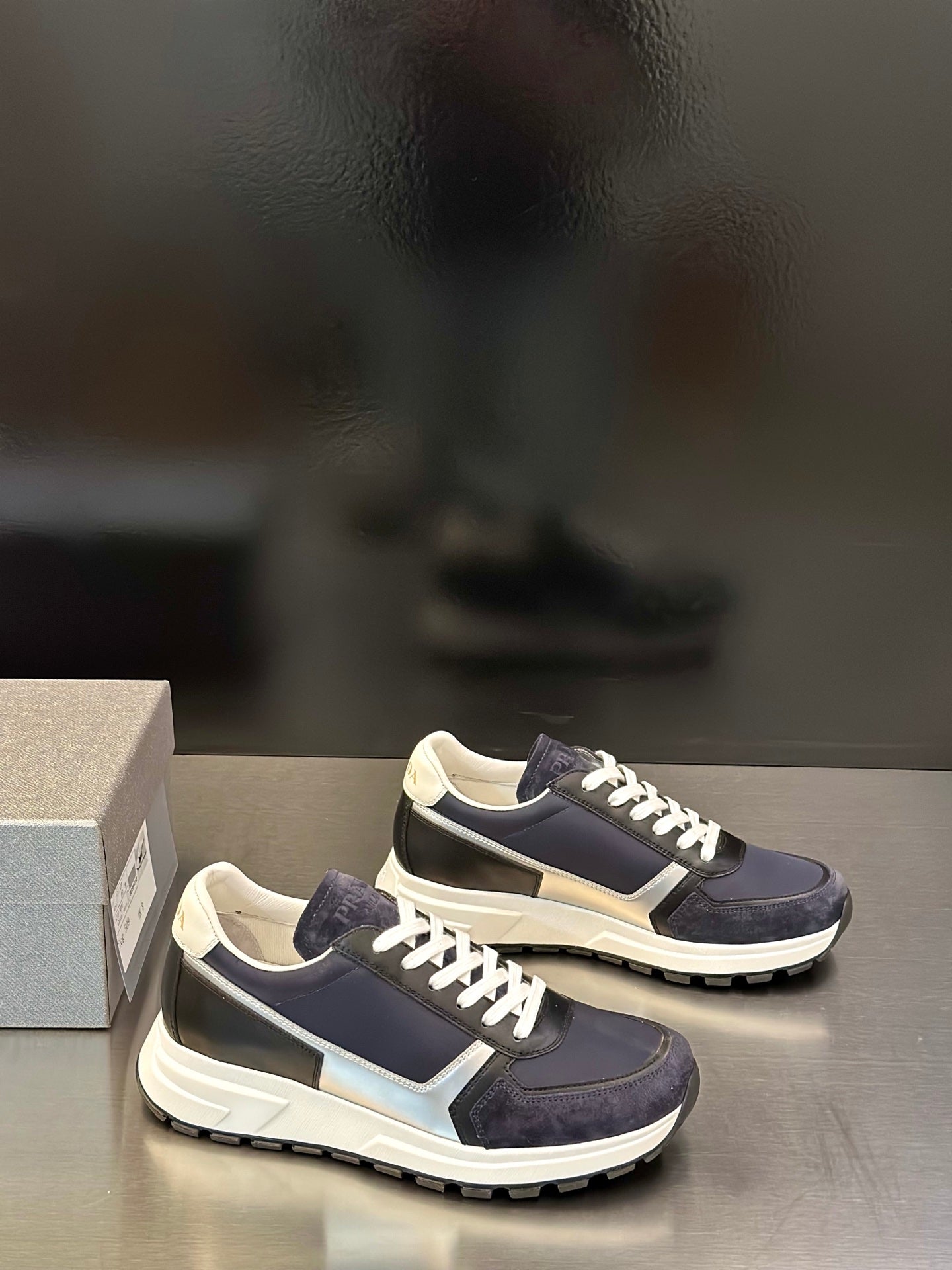 Prada unisex sneakers, navy and cream panels with white lace-up detailing